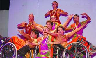 Artistes on wheelchairs perform at the celebrations of the foundation day of the ITDC in New Delhi. 