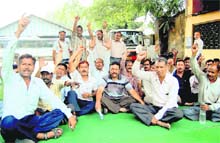 Employees of the Uttarakhand Transport Corporation stage a dharna n Dehradun on Monday.