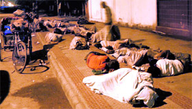 Rickshaw-pullers and beggars sleep in the open near Nirmal Kutia in Karnal.