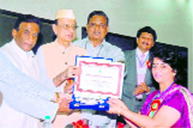 Dr Vijay Sharma of Guru Nanak Khalsa College, Yamunanagar, receives the Bharat Shiksha Ratna award at a function in New Delhi.