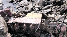 The mangled remains of the van after it was hit by a truck on the Jammu-Srinagar National Highway on Monday.