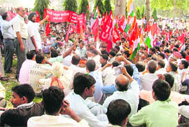 Activists of the Joint Coordination Committee of the Central Trade Unions stage a dharna in Ludhiana on Monday.