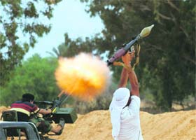 Anti-Gaddafi fighters fire a rocket propelled grenade during fighting in an area around 1 km from the centre of Sirte on Monday