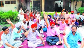 Members of the Guru Nanak Dev University Teachers Union protest against the university authorities outside the Vice Chancellors office in Amritsar on Tuesday