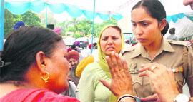 A riot victim argues with a police official during the draw of lots for booths held at PUDA Complex in Sector 62, Mohali, on Tuesday.