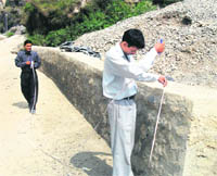 Officials of the Mining Department inspect the area where material mined illegally was allegedly used in Mussoorie. 