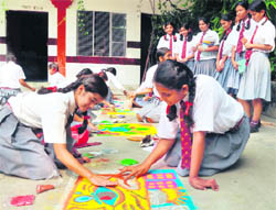 Girl students of Jaswant Modern School make rangoli as part of the Wildlife Week celebrations in Dehradun