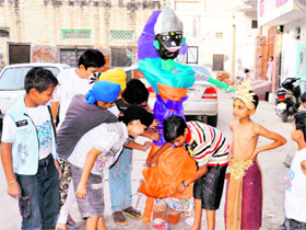 Ahead of Dussehra, children make an effigy of Ravana in Shahkot on Tuesday.