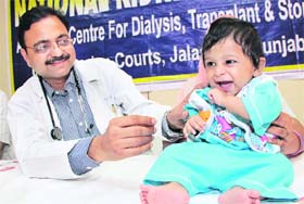 Dr Rajiv Aggarwal holds Aniket at a press conference in Jalandhar on Tuesday