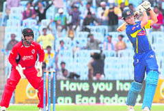 Cape Cobras Dane Vilas plays a shot as Trinidad & Tobago wicket keeper Sunil Narine looks on during their Champions League T20 match in Chennai on Tuesday. T&T won the match by two wickets. 