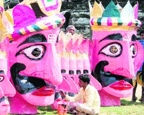 An artist gives final touches to an effigy of Ravana at Dharamsala on Wednesday