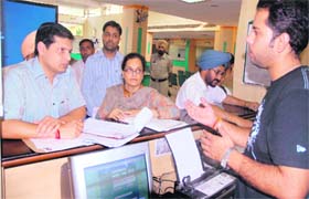 Divisional Commissioner Anurag Verma interacts with staff of the Suvidha Centre in Jalandhar on Wednesday