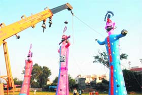 TOWERING EVIL: Effigies of Ravan, Meghnath and Kumbkaran being erected at Master Tara Singh Nagar on the eve of Dasehra on Wednesday