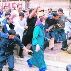 Peoples Democratic Party president Mehbooba Mufti along with party supporters marches towards Lal Chowk in Srinagar on Wednesday. 