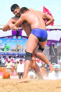 Indias Rubeljeet Singh and Pakistans Ahmad Butt in action during the Preet International Wrestling Tournament in Patiala on Wednesday