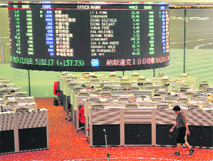 A trader walks the floor at the Hong Kong Stock Exchange on Thursday. Hong Kong shares soared 5.67 percent following a strong performance on Wall Street and on hopes European leaders will agree a plan to resolve the eurozone debt crisis. 