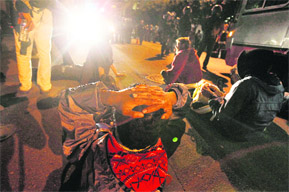 A group of Occupy Wall Street protestors lie in front of a police line after authorities outside the Federal Reserve Bank in San Francisco, Calif