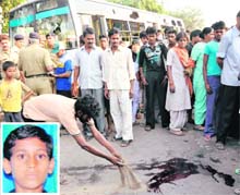 Residents of Colony No. 4, Chandigarh, near the pool of blood where Vikas Kumar (inset) was killed by a CTU bus on Thursday