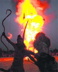 Lord Rama raises his bow, signalling his victory after the effigy of Ravana goes up in flames at Parade Ground, Sector 17, Chandigarh, on Thursday.