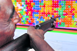 A visitor tries a shot at a game stall