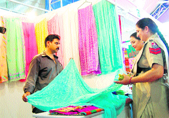 Women constables purchase suit lengths at a stall at Destination Punjab Mega Expo in Amritsar on Friday.
