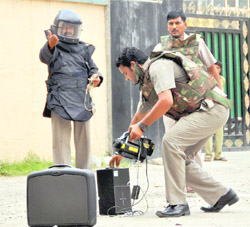 A bomb disposal squad checks the contents of a briefcase that was found on Municipal Road in Dehradun on Friday