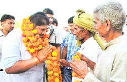INLD nominee Ajay Chautala is greeted by supporters on arrival at Dhani Shobha village near Hisar.