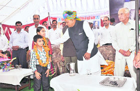 Chief Minister PK Dhumal with the two children who were given Rs 3 lakh as medical assistance from the Chief Ministers Relief Fund on Friday. Photo by writer