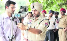 ACP (Traffic) Daljinder Singh Dhillon looks at the demonstration of the laser-operated speed radar with camera in Jalandhar on Friday. 