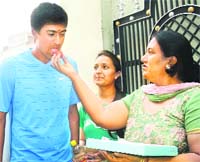 Rahul Sharma being offered sweets by his mother on his return to his home in Jalandhar on Friday. 