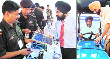 Army officials show spare parts of different weapons to industrialists at Destination Punjab Mega Expo in Amritsar on Friday; (right) Deputy Chief Minister Sukhbir Singh Badal and BJP MP Navjot Singh Sidhu on a tractor at the expo. 