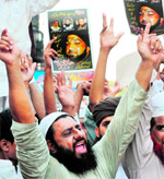 Activists of Jamaat-e-Sunnah and supporters of convicted killer Mumtaz Qadri shout slogans during a rally in Lahore on Friday.