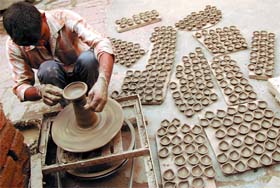 A potter making Diyas for the festival of lights in Bathinda on Saturday. 