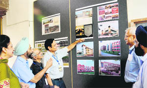 Alumni of the Chandigarh College of Architecture have a look at the exhibits as part of golden jubiliee celebrations on the college campus on Saturday. 