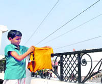 A child standing near high-tension wires in Guru Nanakpura in Jalandhar. 