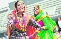 Girls perform gidha during the opening ceremony of the Punjab Women's Games; and (right) Cabinet Minister Hira Singh Gabria and Director Sports Pargat Singh release balloons at Guru Nanak Stadium in Ludhiana on Saturday.