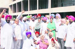 Congress legislators raise slogans outside the Punjab Vidhan Sabha in Chandigarh on Saturday. 