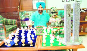 Dr Harvinder Singh with pieces of miniature art work in Amritsar on Sunday