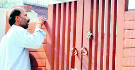 An employee of the Uttarakhand Power Corporation conducts a check at a house in Haridwar for the misuse of electricity meters.