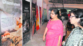 Visitors look at exhibits in the Bharat Soka Gakkai exhibition on peace at the Scholars Home in Dehradun on Sunday.