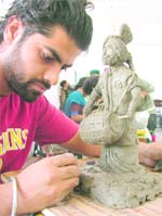A student participates in a clay- modelling competition at the youth festival of GADVASU in Ludhiana on Sunday. 