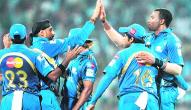 Mumbai Indians Kieron Pollard (R) celebrates with teammates during the Champions League Twenty20 final match against RCB at the M.A Chidambaram Stadium in Chennai on Sunday