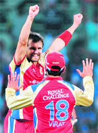 RCBs Dirk Nannes (L) and Virat Kholi celebrate the dismissal of Mumbai Indians Aiden Blizzard during the Champions League Twenty20 final at the M.A Chidambaram Stadium in Chennai on Sunday