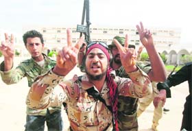 NTC fighters celebrate after seizing control of the University of Sirte on Sunday