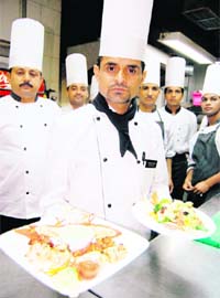 Chef Pawan Sharma presents delicacies prepared by him at a hotel in Amritsar on Monday