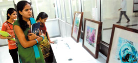 Visitors admire the paintings by French artist Martine Le Cam at an exhibition of her works at the Central University in Bathinda on Monday.