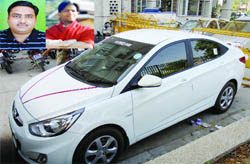 A security guard stands near the ill-fated brand new Hyundai Verna car at the Rohini South police station in Sector 3, two businessmen cousins (inset) found dead in the car on Sunday night. 