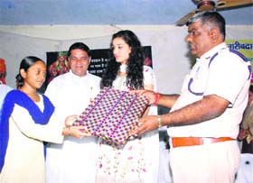 Kanishtha Dhankhar, Miss India - 2011, gives away a prize to a meritorious student at a function in Jhajjar. 