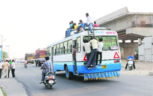 People travelling on rooftops of Haryana Roadways buses is a common sight in Karnal. 