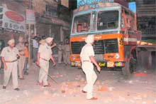 Policemen inspect the spot and the vehcile that crushed two girls (inset) Sanjna and Sneha to death during a procession organised on the eve of Valmiki Jayanti at Phagwara Gate in Jalandhar on Monday night.